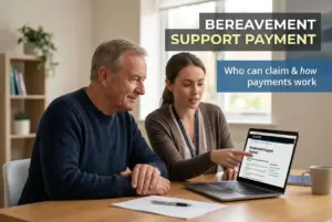 Senior man and young woman discussing Bereavement Support Payment on a laptop